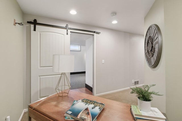 dining room featuring carpet and a barn door