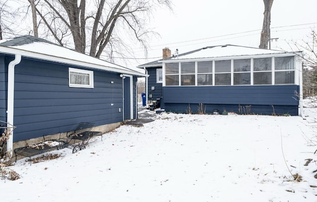 view of snow covered back of property