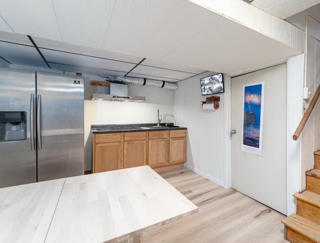 kitchen with stainless steel fridge, sink, and light hardwood / wood-style flooring