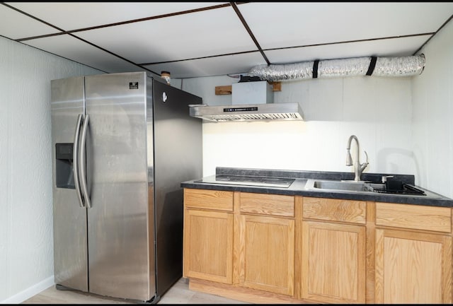 kitchen with sink, stainless steel fridge, light brown cabinetry, extractor fan, and electric stovetop