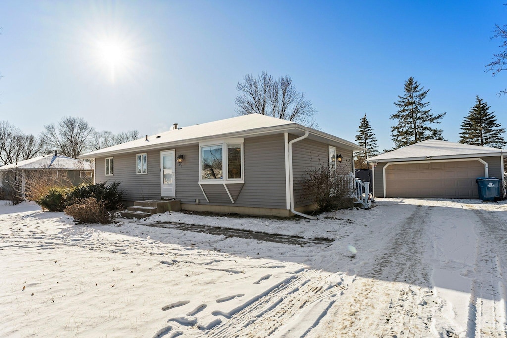 view of front of property featuring a garage and an outdoor structure