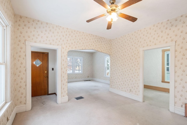 unfurnished room with ceiling fan and light colored carpet