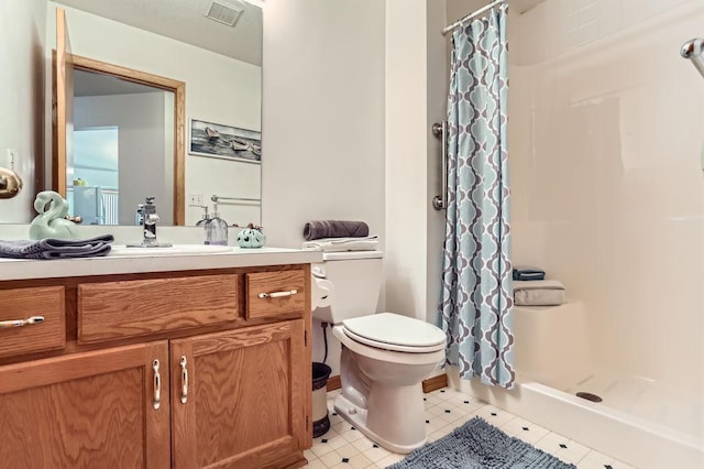 bathroom with vanity, tile patterned floors, toilet, and a shower with shower curtain