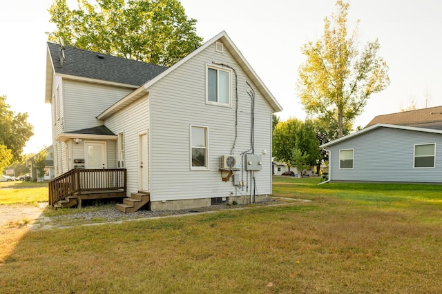 rear view of property featuring a lawn