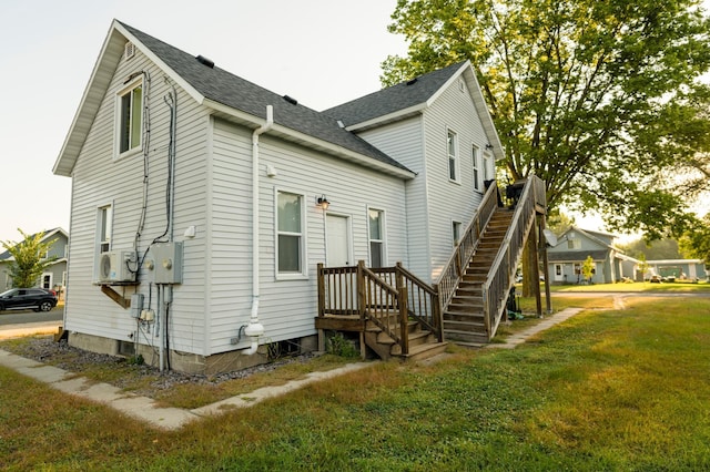 rear view of house with a yard