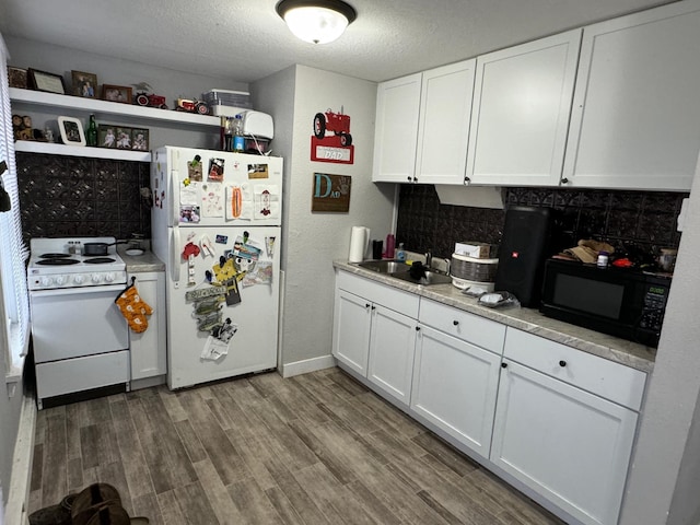 kitchen with backsplash, white appliances, sink, wood-type flooring, and white cabinetry