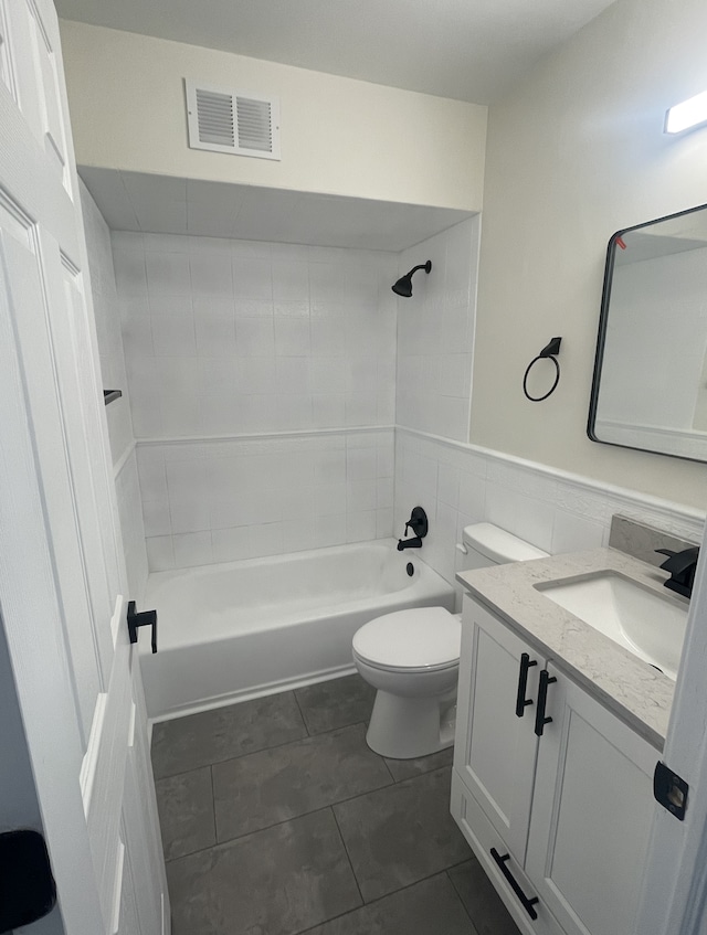 full bathroom featuring vanity,  shower combination, tile walls, tile patterned flooring, and toilet