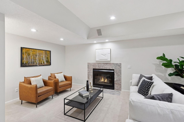 living room with a high end fireplace and light carpet