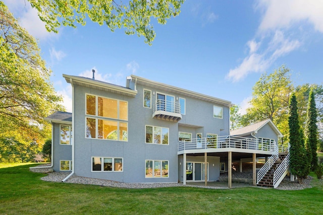 rear view of property with a deck and a lawn