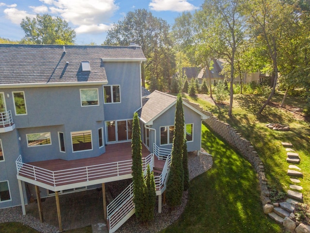 rear view of property with a yard and a deck