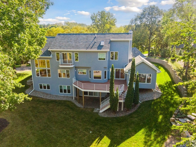 rear view of house featuring a lawn