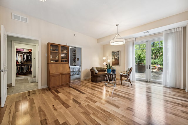 sitting room featuring french doors and light wood-type flooring