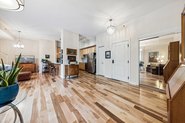 interior space with a notable chandelier and light hardwood / wood-style floors