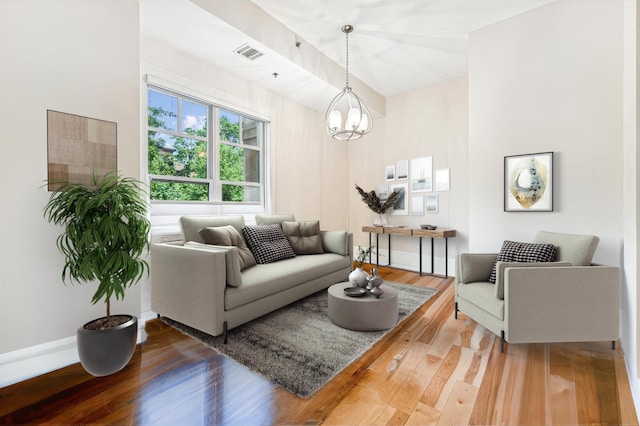 living room featuring an inviting chandelier and hardwood / wood-style flooring