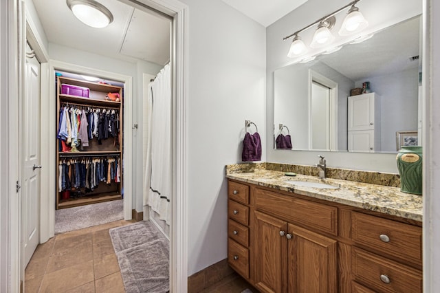 bathroom with vanity, tile patterned flooring, and curtained shower