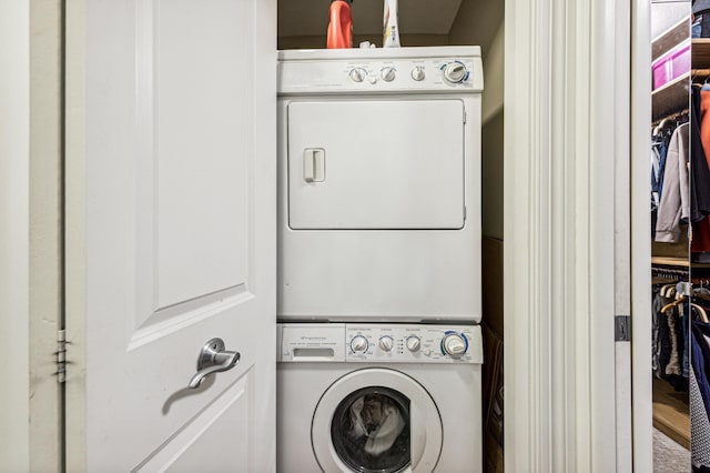 laundry room featuring stacked washing maching and dryer