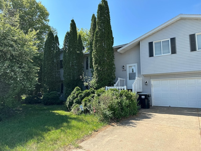 1028 241st Ave NE, East Bethel, MN 55005 - split level home with concrete driveway and a garage