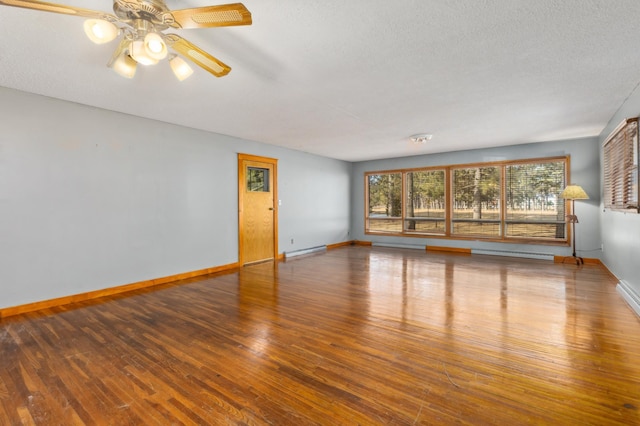 unfurnished living room featuring baseboards, ceiling fan, hardwood / wood-style flooring, a baseboard heating unit, and baseboard heating