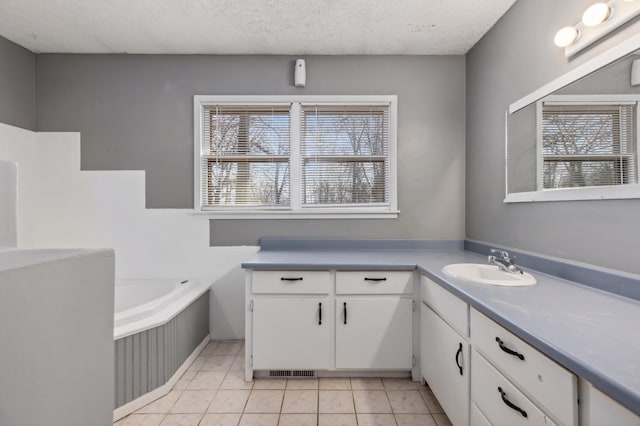 full bath featuring tile patterned floors, a textured ceiling, vanity, and a bath