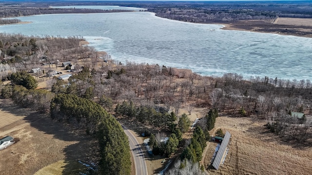 aerial view with a wooded view and a water view