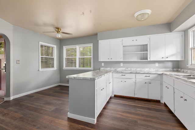 13749 County Road 116, Merrifield, MN 56465 - kitchen featuring arched walkways, ceiling fan, a peninsula, open shelves, and light countertops