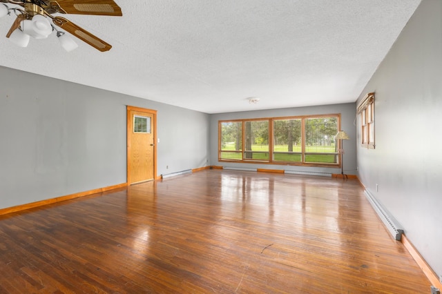 13749 County Road 116, Merrifield, MN 56465 - spare room featuring a baseboard radiator, a baseboard heating unit, baseboard heating, hardwood / wood-style flooring, and a ceiling fan