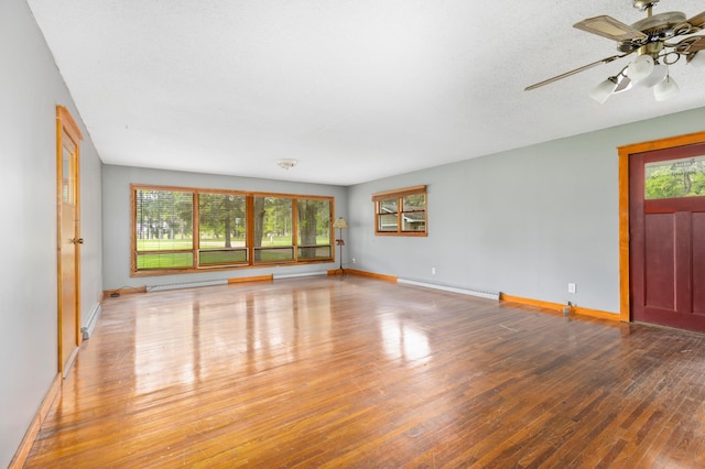 13749 County Road 116, Merrifield, MN 56465 - spare room with a baseboard heating unit, wood finished floors, and baseboards