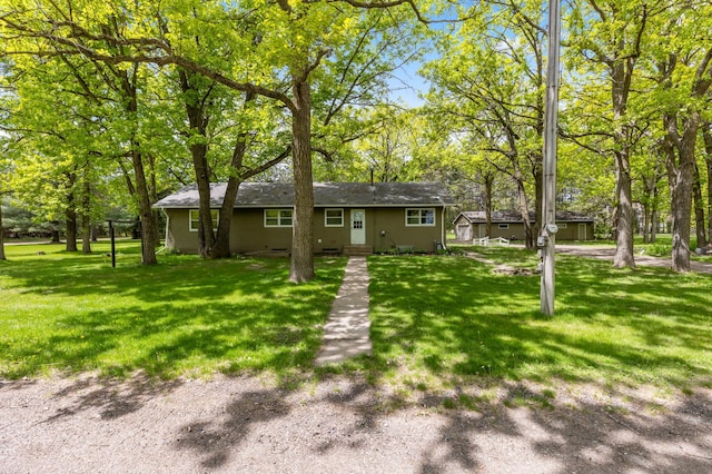 13749 County Road 116, Merrifield, MN 56465 - view of front of home with a front lawn, stucco siding, and view of wooded area