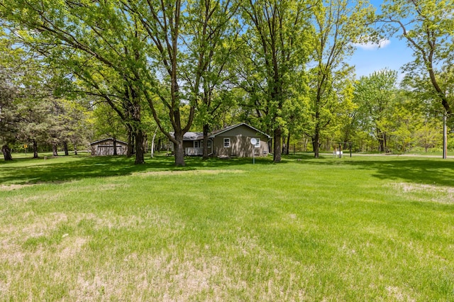 13749 County Road 116, Merrifield, MN 56465 - view of green lawn featuring view of wooded area