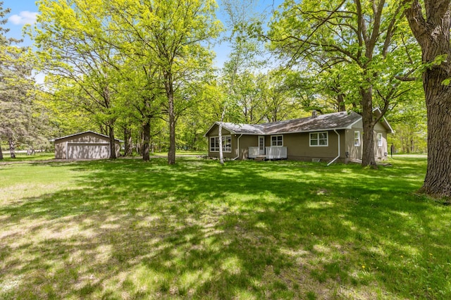 13749 County Road 116, Merrifield, MN 56465 - view of green lawn with a garage and covered porch