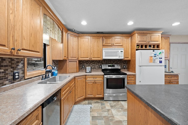 kitchen with backsplash, stainless steel appliances, and sink