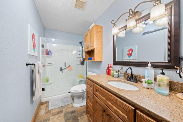 bathroom featuring vanity, toilet, a textured ceiling, and walk in shower