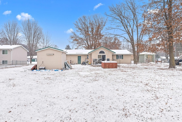 view of snow covered rear of property