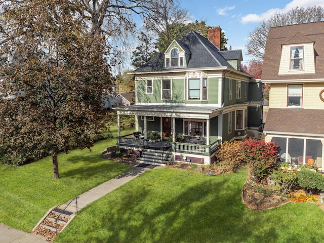 view of front of home with a front yard and a porch