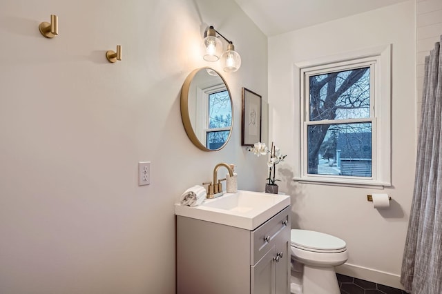 bathroom with vanity, toilet, and tile patterned flooring