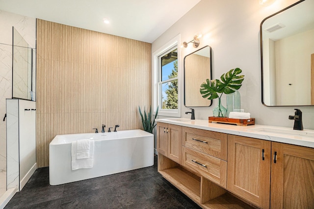 bathroom with a washtub and vanity