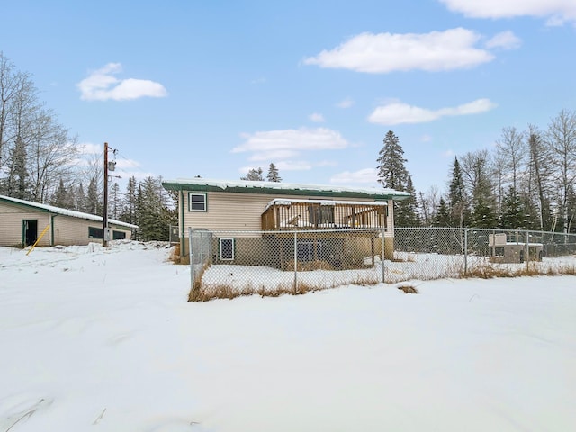 snow covered house featuring a deck