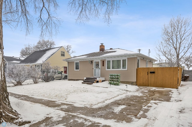 view of snow covered back of property