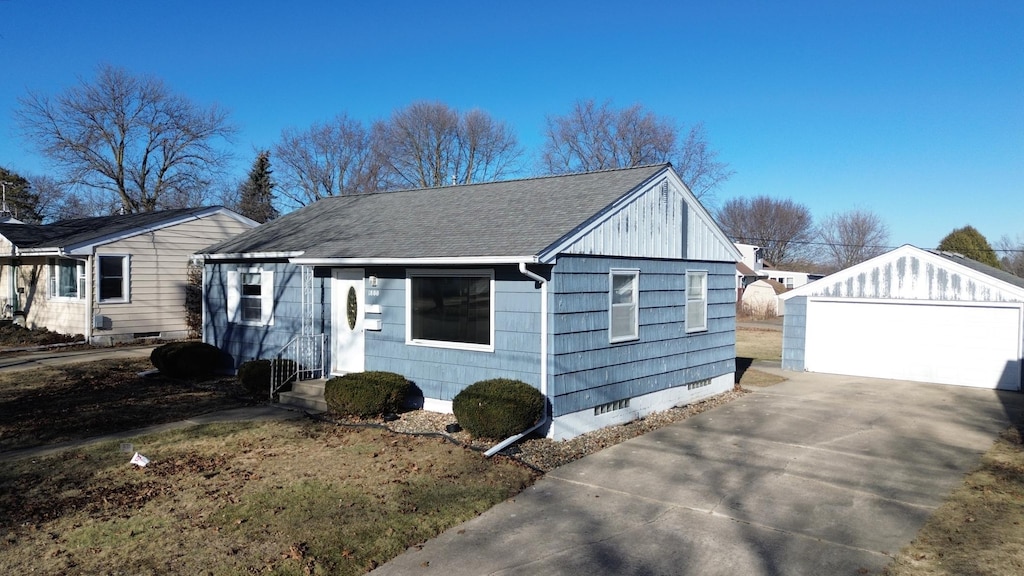 view of home's exterior with a garage and an outdoor structure