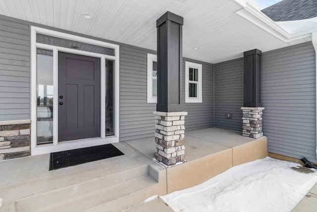 view of exterior entry with covered porch