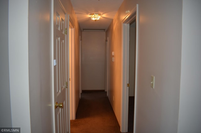 hallway with dark carpet