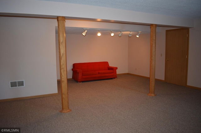 basement featuring a textured ceiling and carpet floors