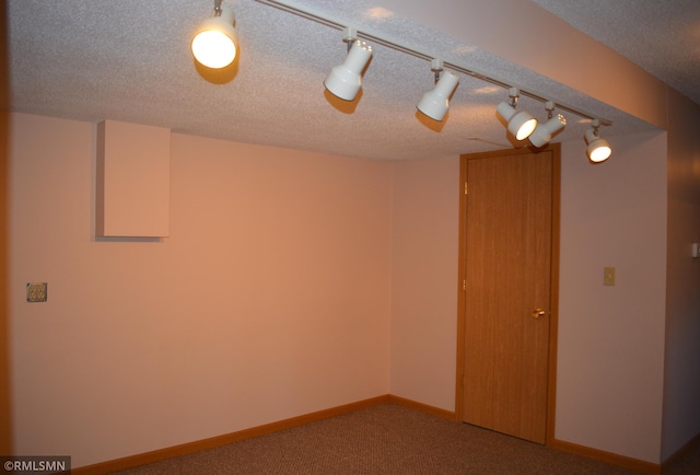 unfurnished room with carpet floors and a textured ceiling