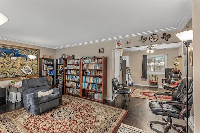 living area featuring hardwood / wood-style flooring, ceiling fan, ornamental molding, and a textured ceiling