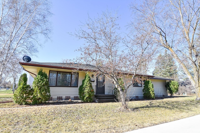 ranch-style home featuring a front yard