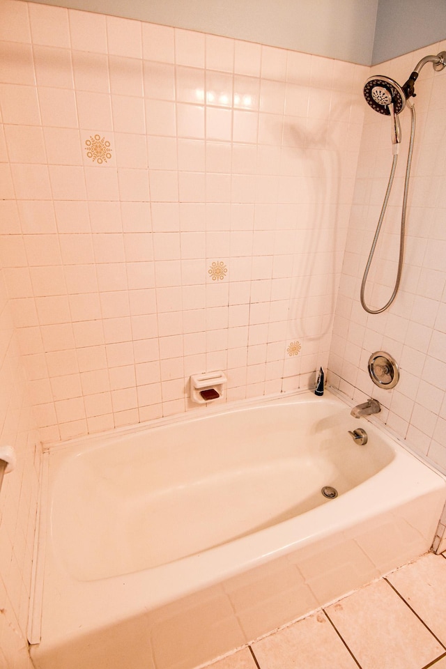 bathroom with tile patterned flooring and tiled shower / bath