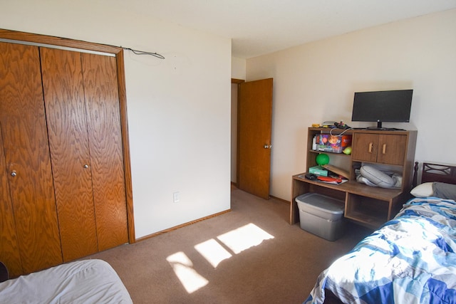 bedroom with light colored carpet and a closet