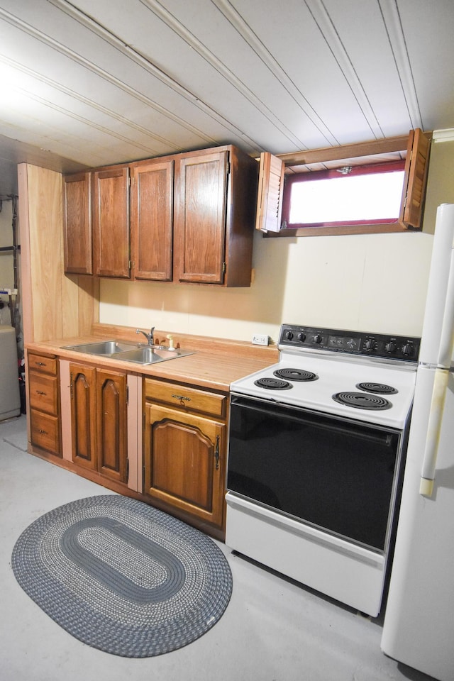 kitchen with sink, white appliances, and washer / dryer