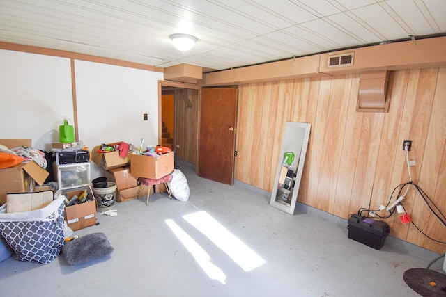 basement featuring wood walls