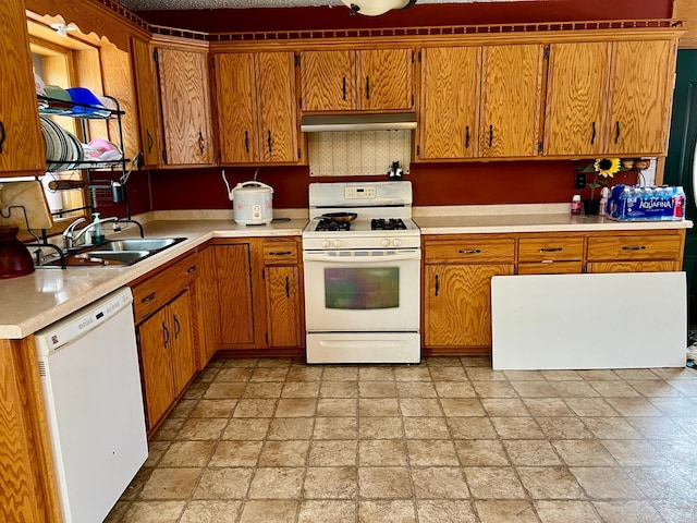 kitchen with white appliances, sink, and exhaust hood